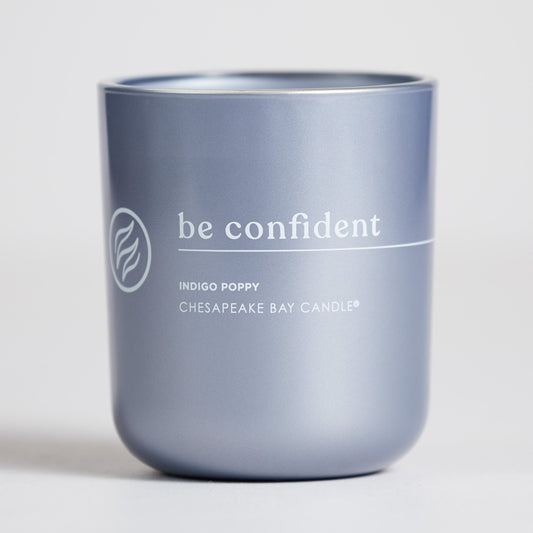 chesapeake bay candle intentions collection be confident indigo poppy medium two wick candle in a white backdrop